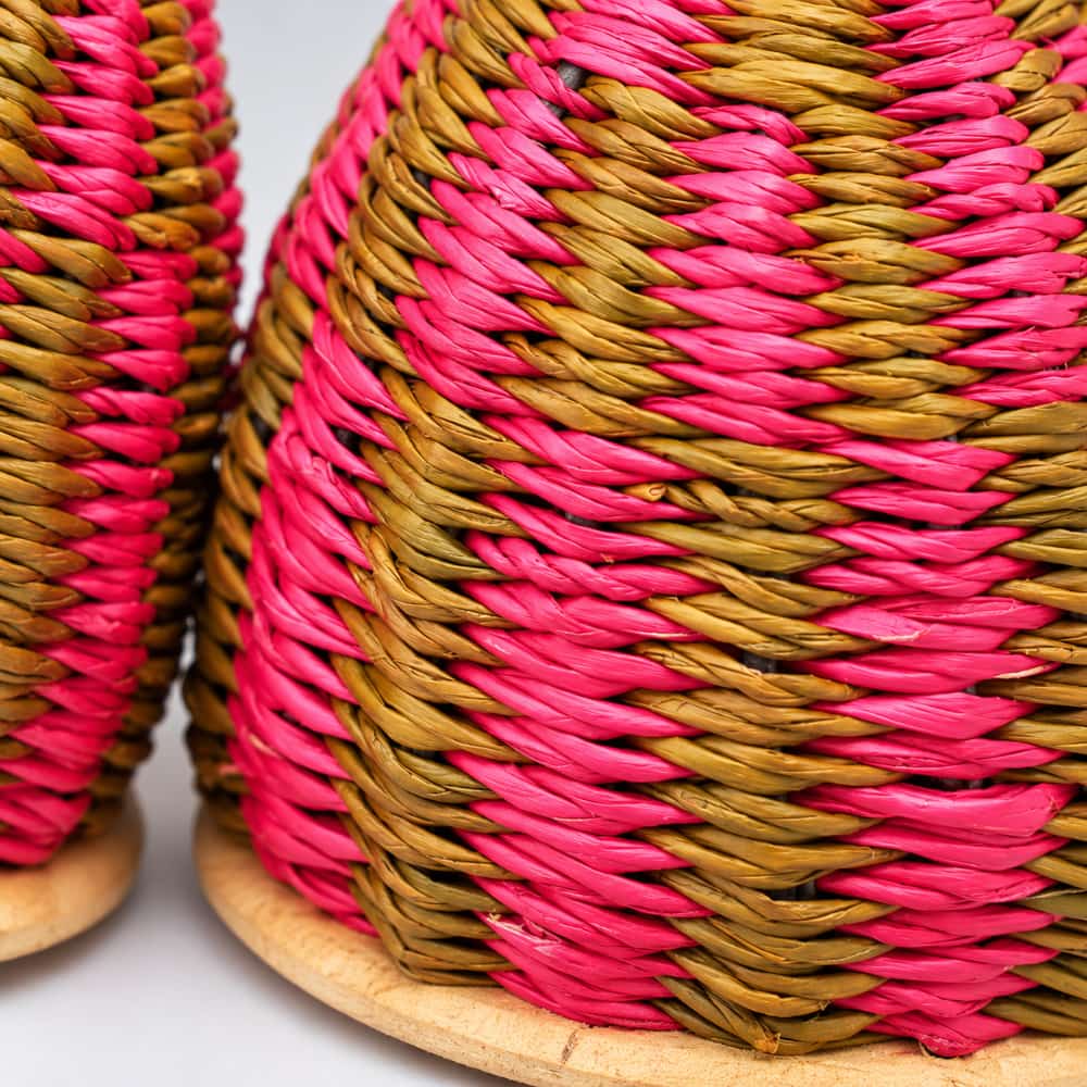 Close-up of the double caxixi shaker, highlighting the pink and brown straw details.