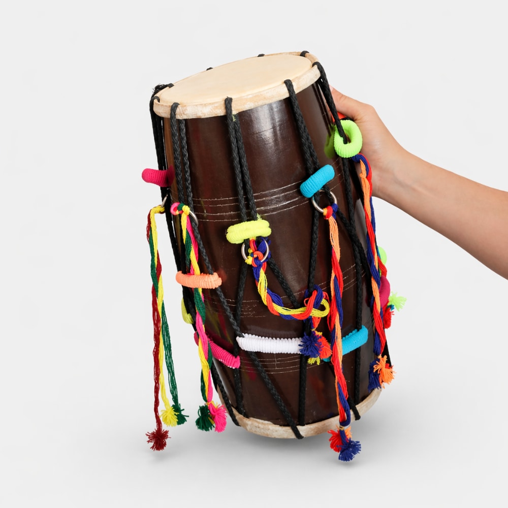 Hand holding a dholak drum with colorful strings on a white background