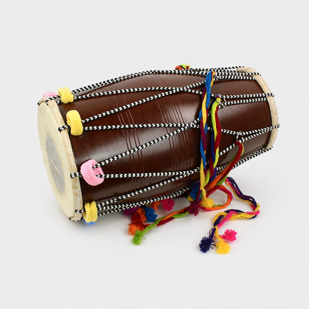 brown dhol drum laying on white background 