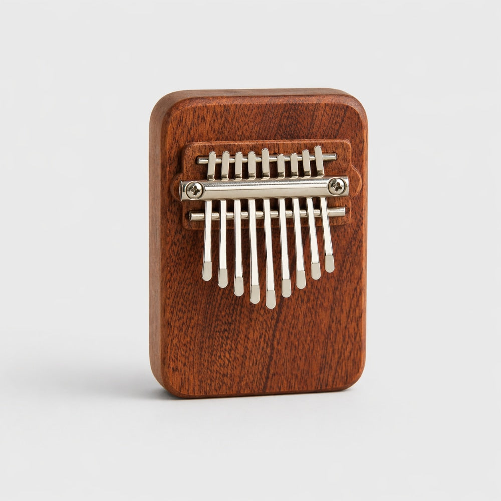 Wooden Gansu Kalimba with 9 metal note tines on a light gray studio background