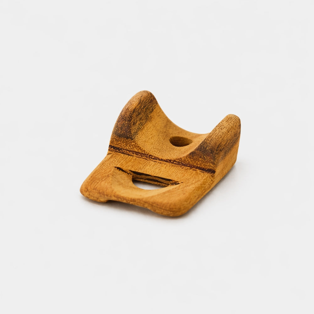 wooden nose flute laying flat on grey background 