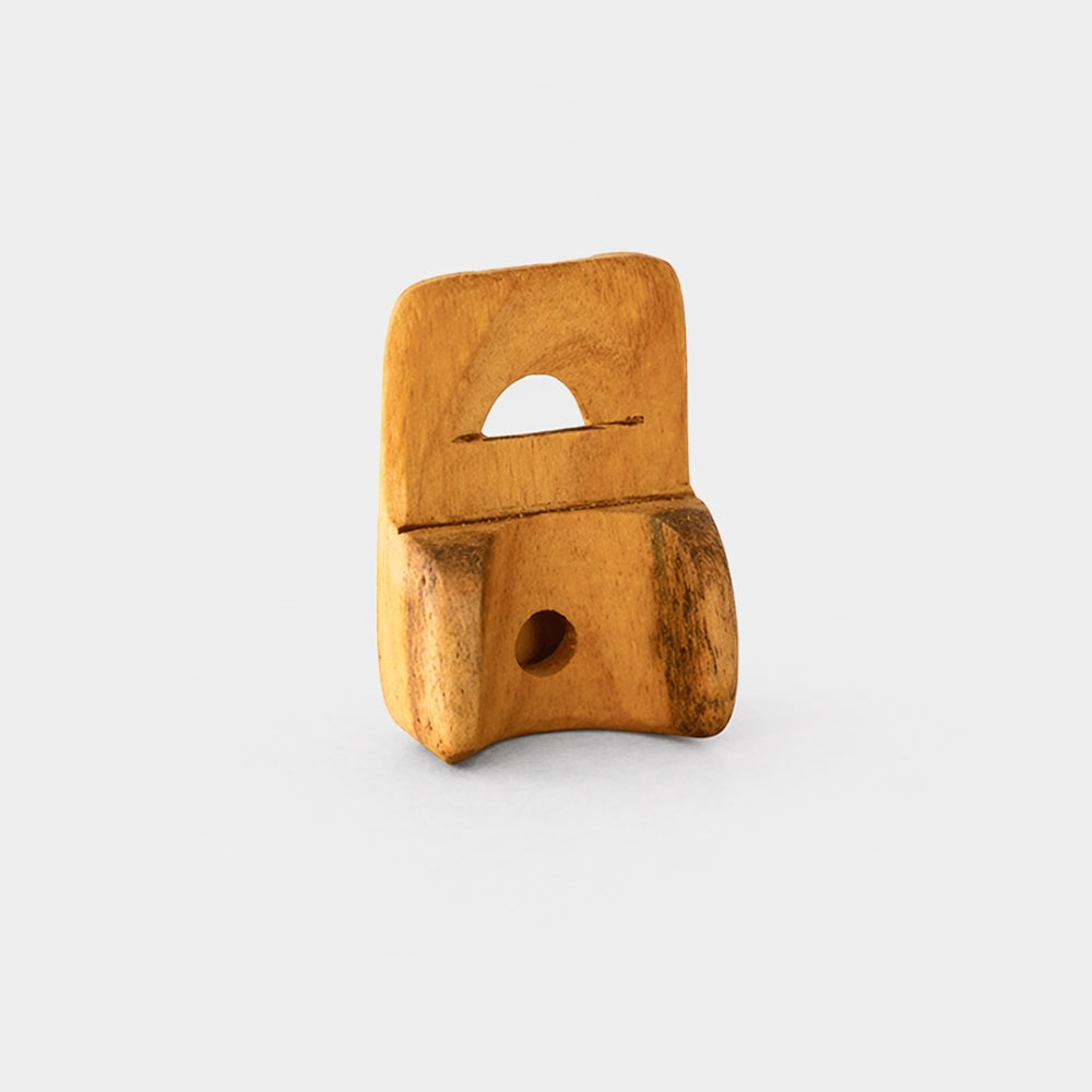 jackfruit wood nose flute standing on grey backdrop 