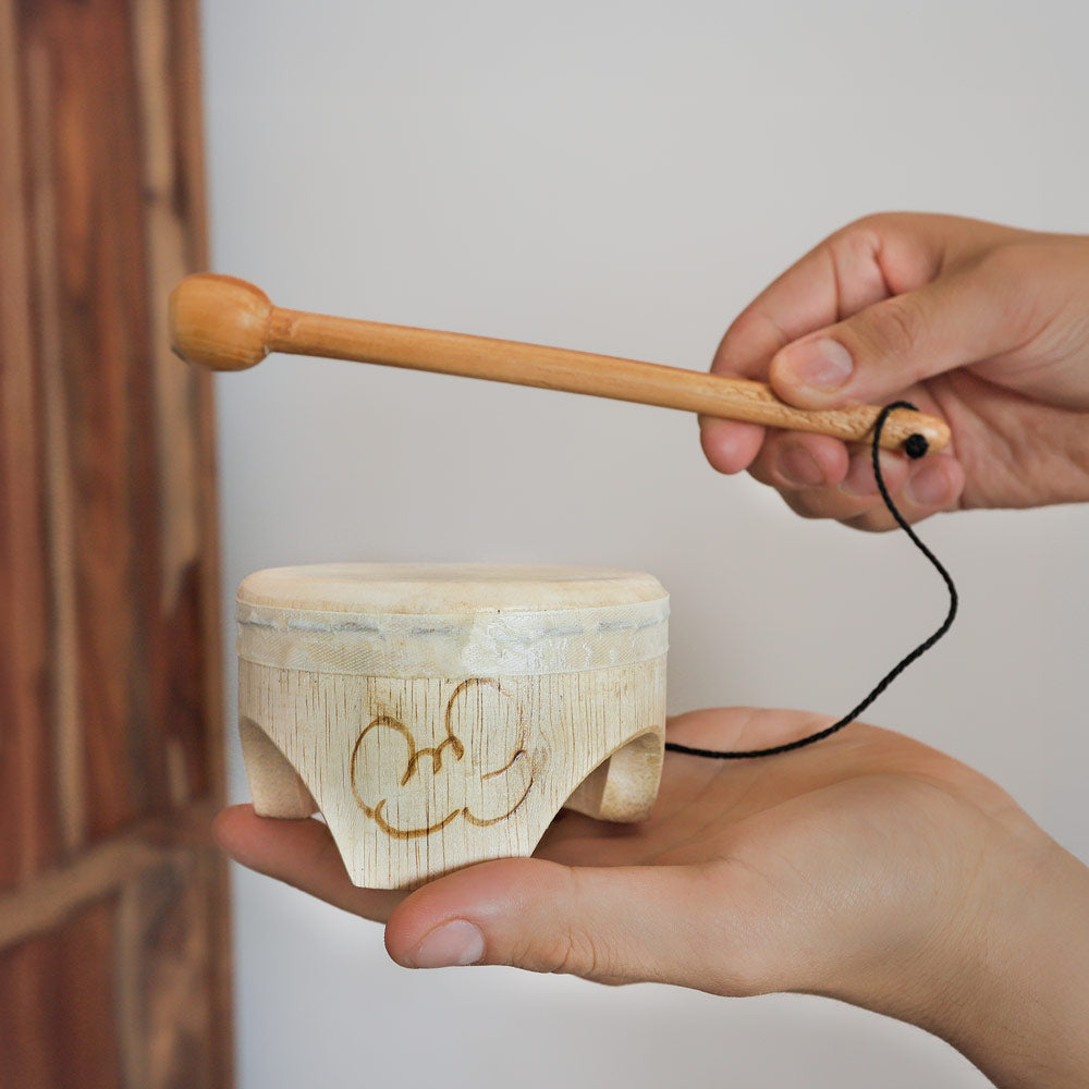 jati baby drum hand drum with beater in hand 