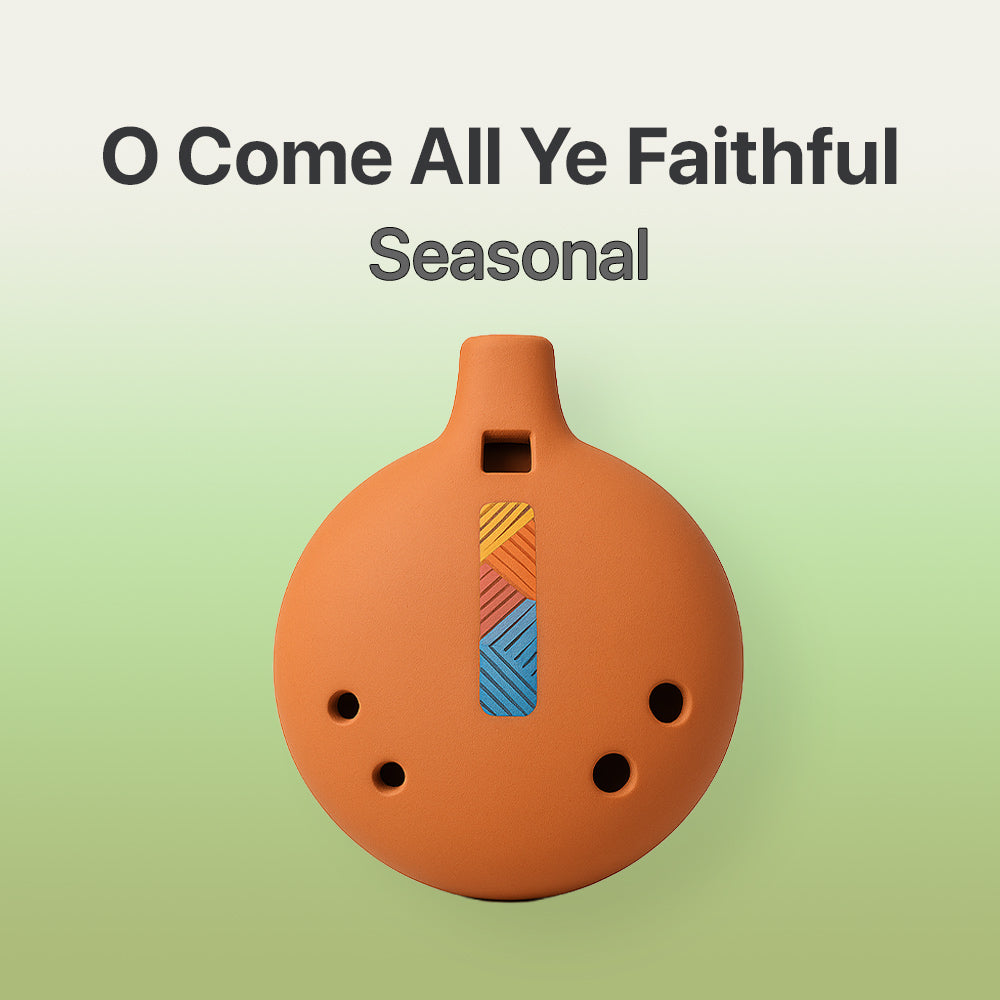 Ceramic ocarina with colorful design on a light green background, featuring text 'O Come All Ye Faithful Seasonal'.