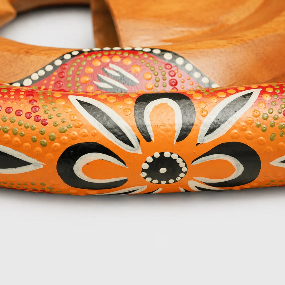 Close-up of the hand-painted design on the wood of the Spiral didgeridoo, showcasing intricate artwork.