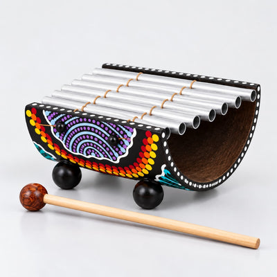 7 note dot painted indonesian gamelan on a light grey studio background
