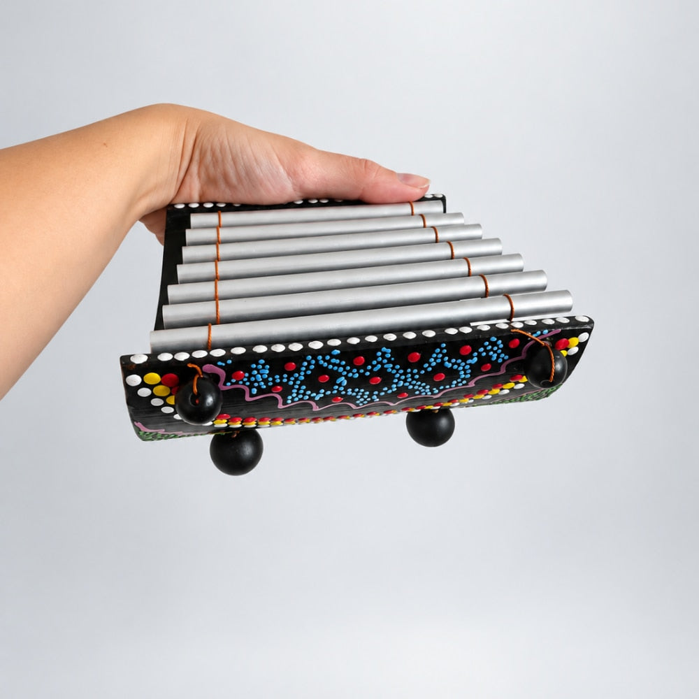 hand holding penebel gamelan