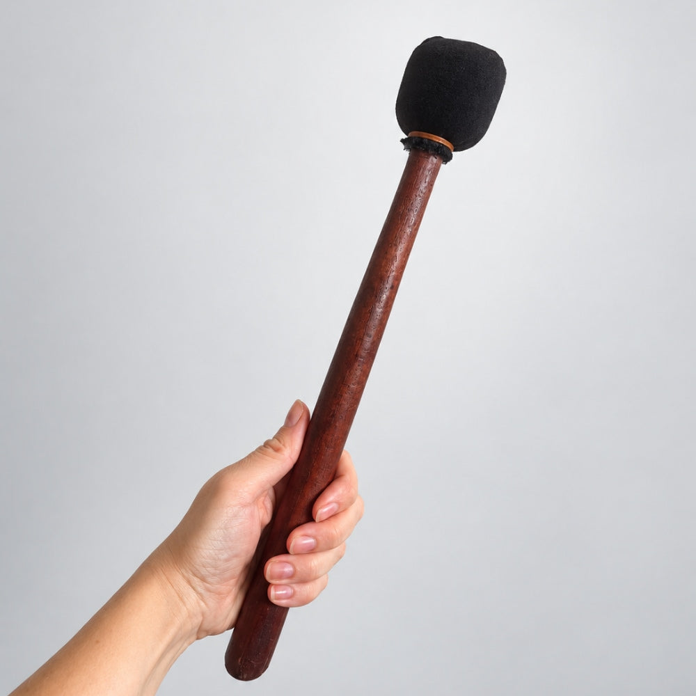 hand holding shamanic drum beater