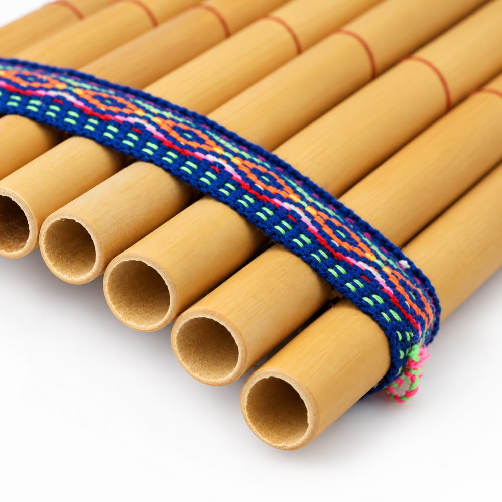 Close up of the top of the bamboo panpipes pan flute showing the holes for blowing and the woven band