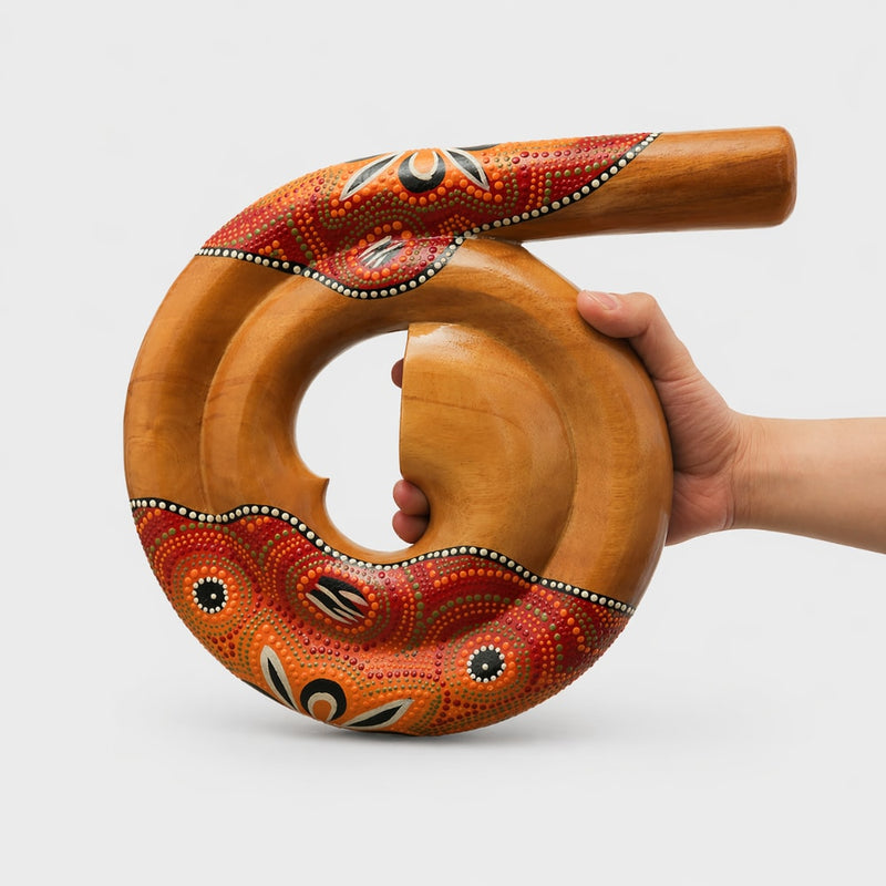 hand holding orange didgeridoo spiral woodwind 