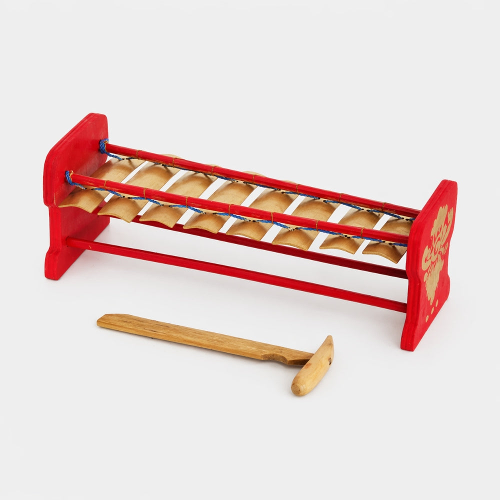 red balinese xylophone with mallet on grey background 