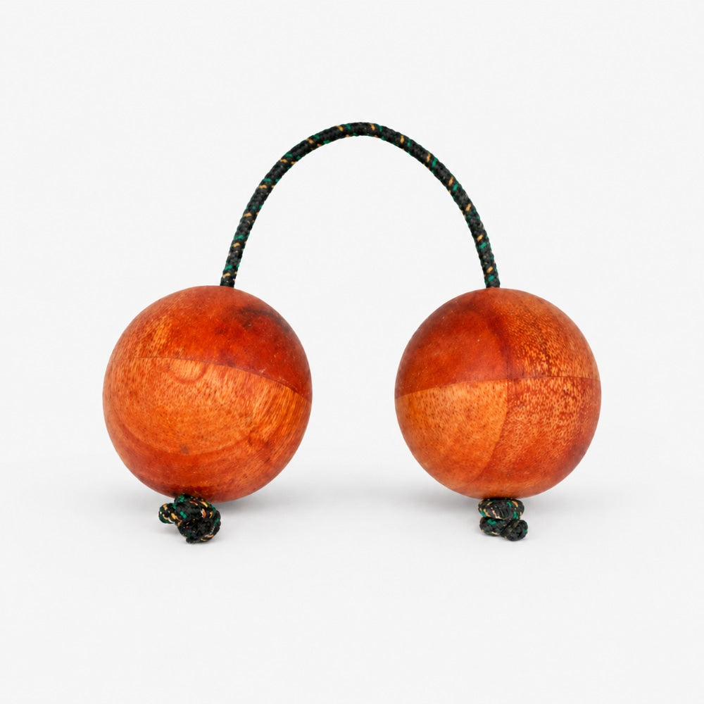 Single wooden kashaka shaker on a light grey studio background